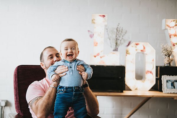 Dad with baby laughing